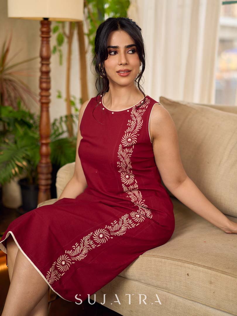 Maroon block printed sleeveless dress with hand block printed floral side panel, off-white accents, and pearl embellishments for a refined, elegant look.