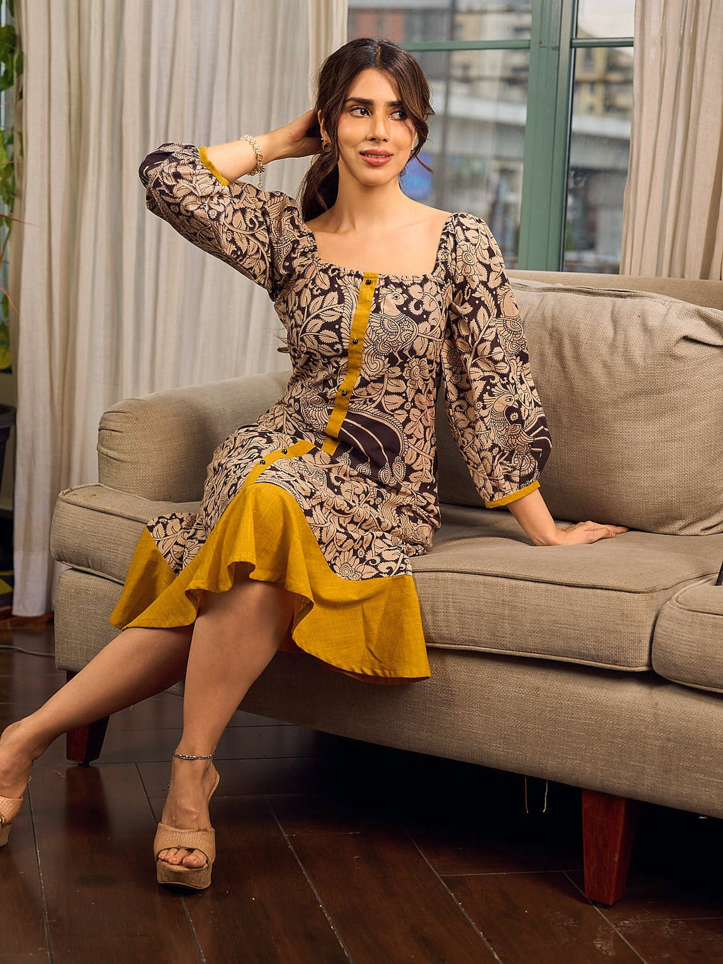 Heritage Kalamkari dress with elegant mustard accents and black pearl embellishments.