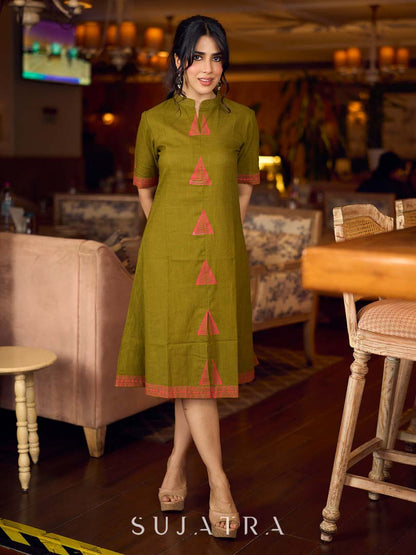 Gorgeous olive dress with pink abstract triangle hand block prints placed at the centre, sleeves, and back, featuring a mandarin collar and half sleeves for a refined, contemporary look.