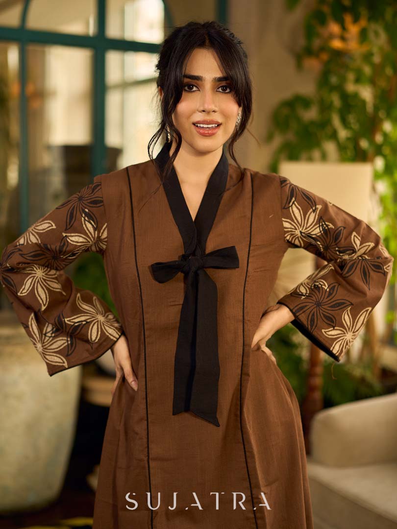 Brown block print dress with floral block printed flared sleeves, black tie-up neckline, and contrast black accents for an effortless, elegant everyday look.