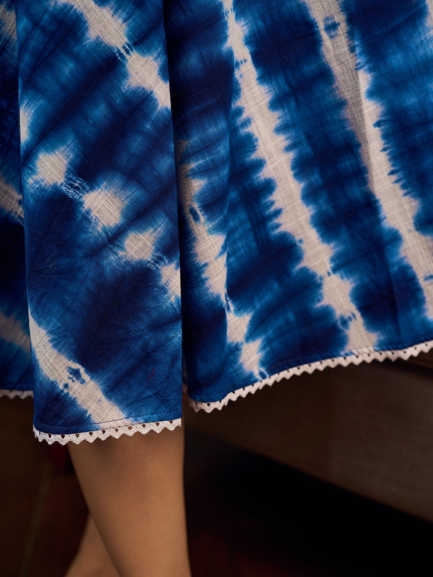 Beautiful blue shibori tie dye slip dress featuring handcrafted patterns and elegant lace accents.