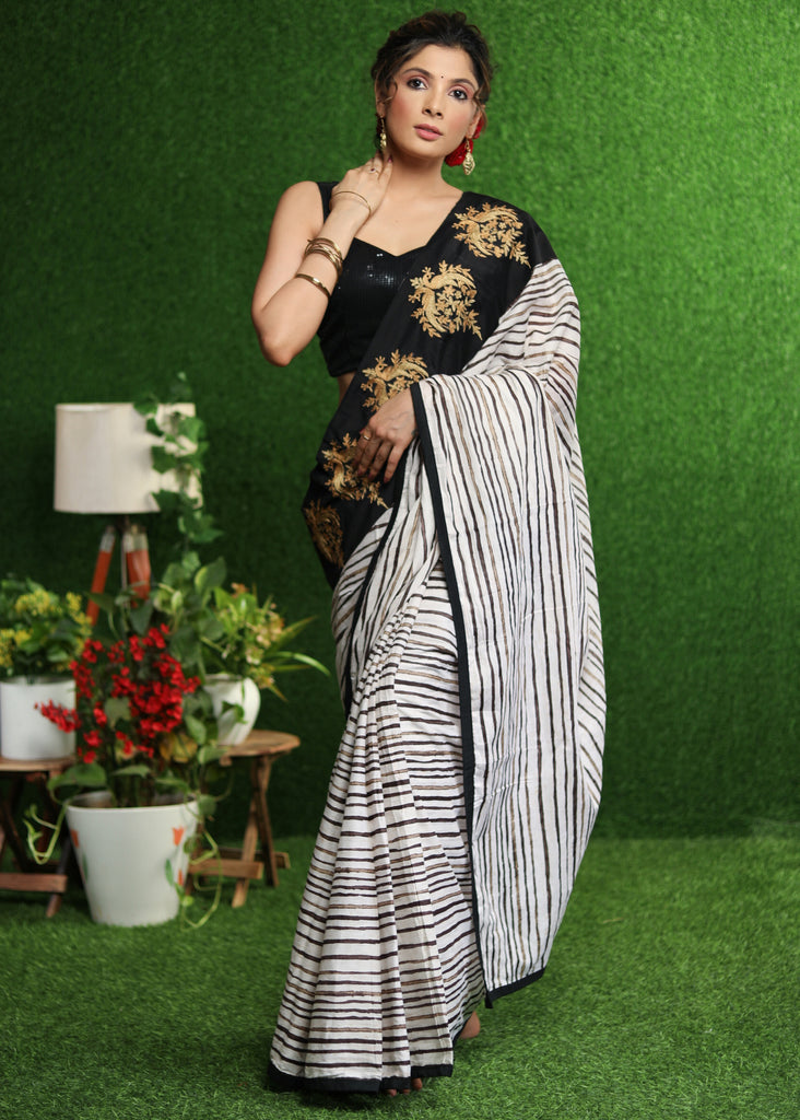 Gorgeous white striped saree with gold embroidered border on pallu
