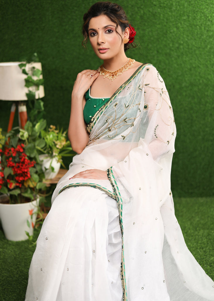 Elegant white saree with delicate hand-embroidery and green Banasari border