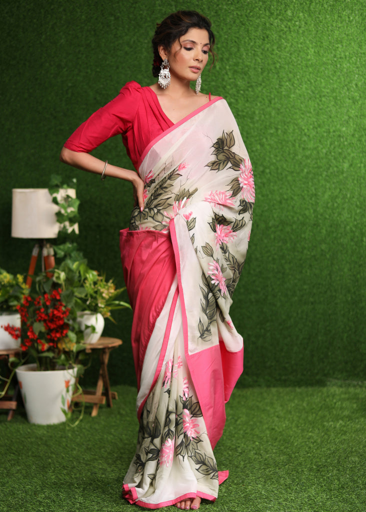 Beautiful white chiffon saree with pink hand painted floral motif & pink border