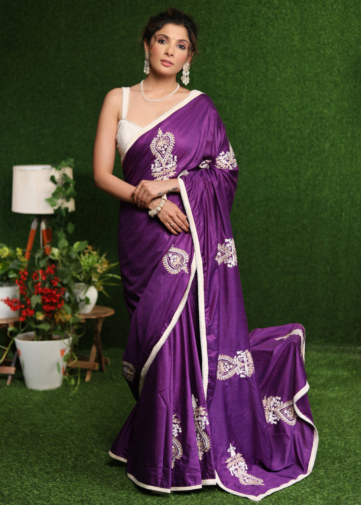 Elegant purple cotton Silk saree with beige embroidery motifs.