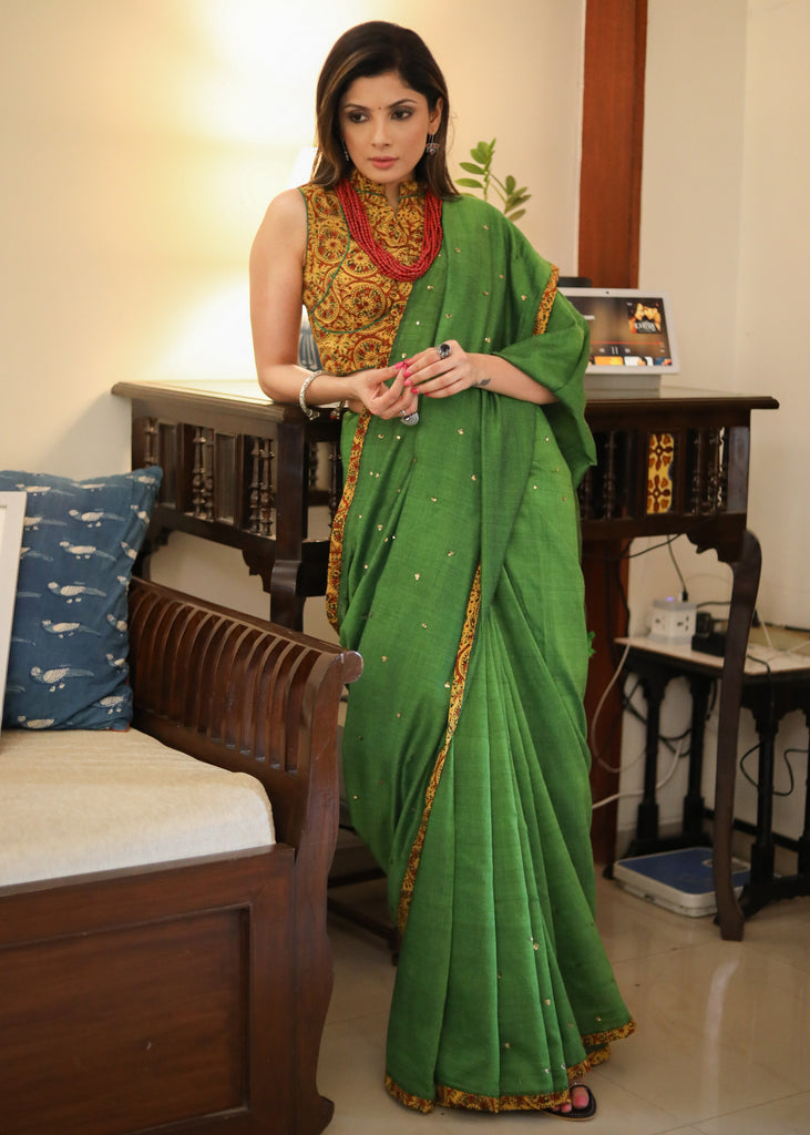 Graceful green Cotton saree with yellow Ajrakh border and golden embellishment