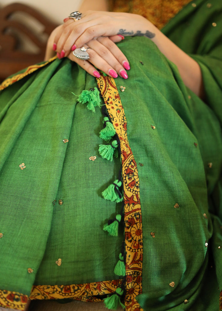 Graceful green Cotton saree with yellow Ajrakh border and golden embellishment