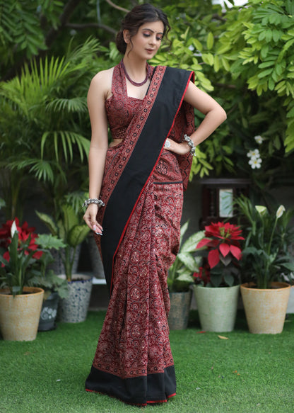 Dussehra Sale — Sensuous maroon Ajrakh saree with black border & Accentuated with stone embellishment.