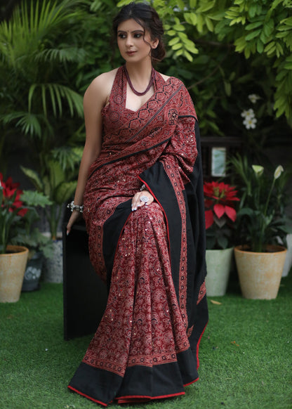 Dussehra Sale — Sensuous maroon Ajrakh saree with black border & Accentuated with stone embellishment.