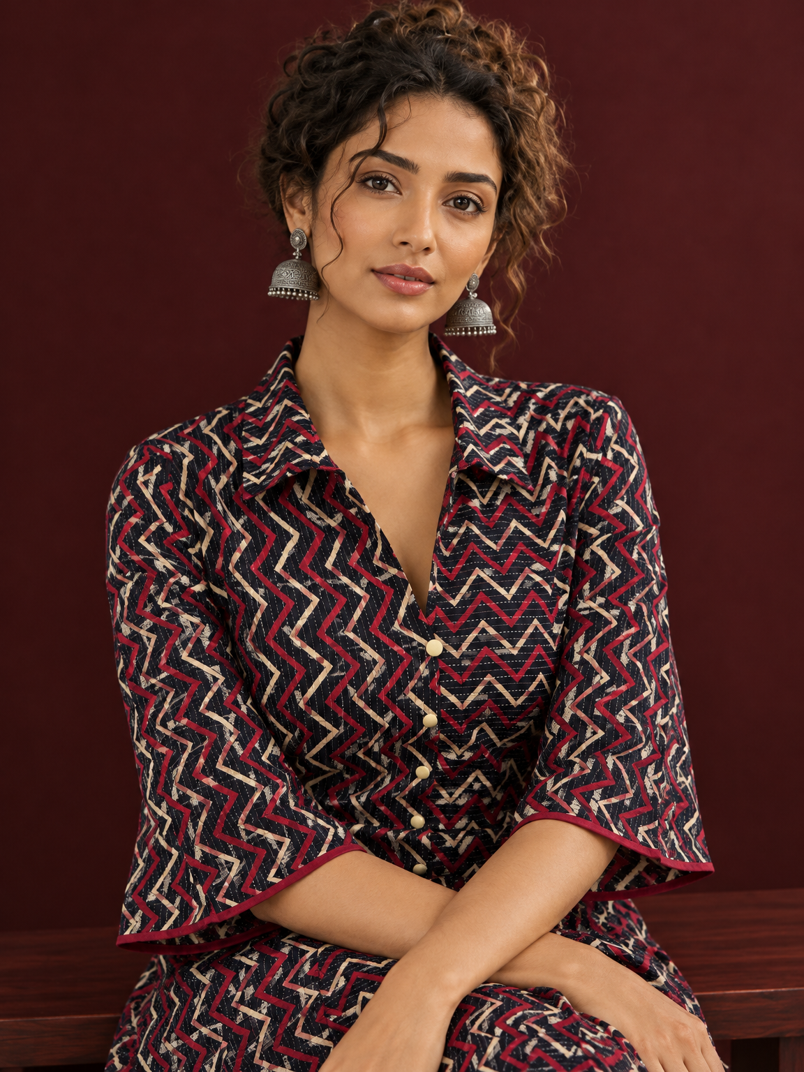 Bold Black Ajrakh Cotton Shirt Dress with Red & Beige Zigzag Print and Kantha Detailing — seated detail — view 5