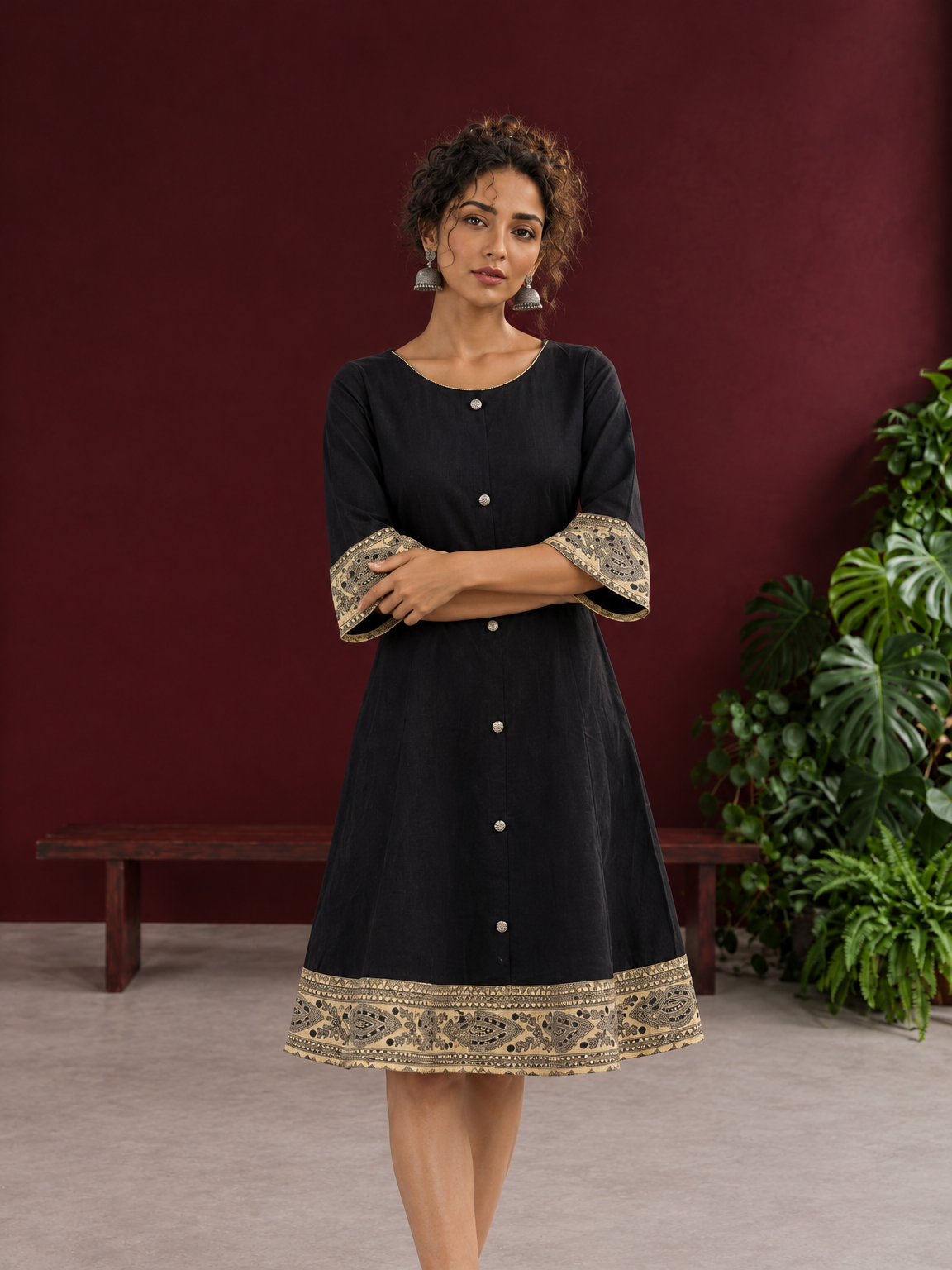 Elegant Black Cotton A-Line Dress with Madhubani Print Border Hem and Matching Bell Sleeve Cuffs — styled view — view 3