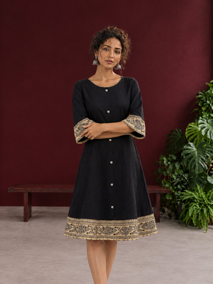 Elegant Black Cotton A-Line Dress with Madhubani Print Border Hem and Matching Bell Sleeve Cuffs — styled view