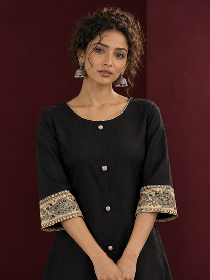 Elegant Black Cotton A-Line Dress with Madhubani Print Border Hem and Matching Bell Sleeve Cuffs — fabric detail