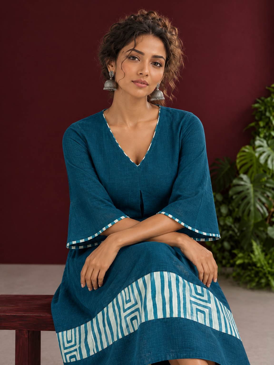 Teal Blue Cotton Dress with Abstract Print Hem Panel and Sleeve Cuffs — seated detail — view 4