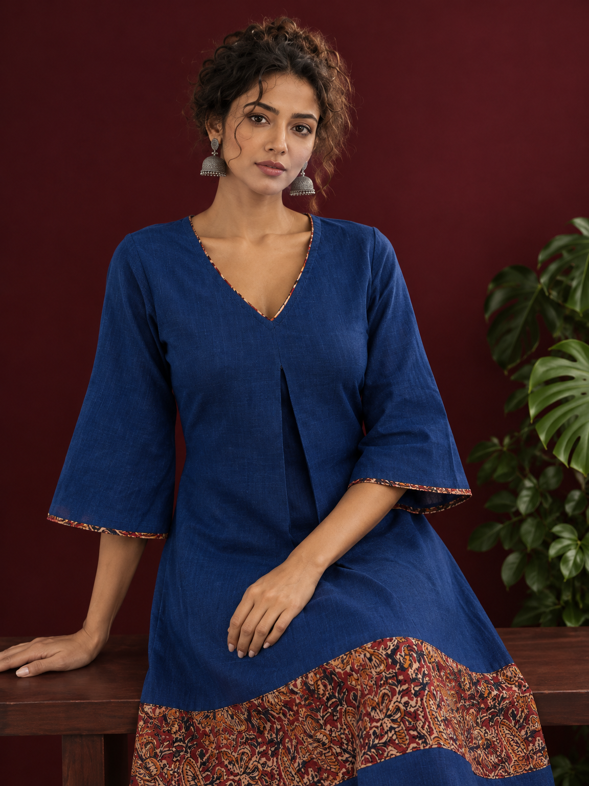 Timeless Navy Blue Cotton Dress with Kalamkari Print Hem Border & Contrast Neckline and Cuff Trim — seated detail — view 5
