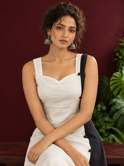 Elegant Off-White Cotton A-Line Dress with Contrast Black Pinstripe Side Panel & Button Detailing — seated detail