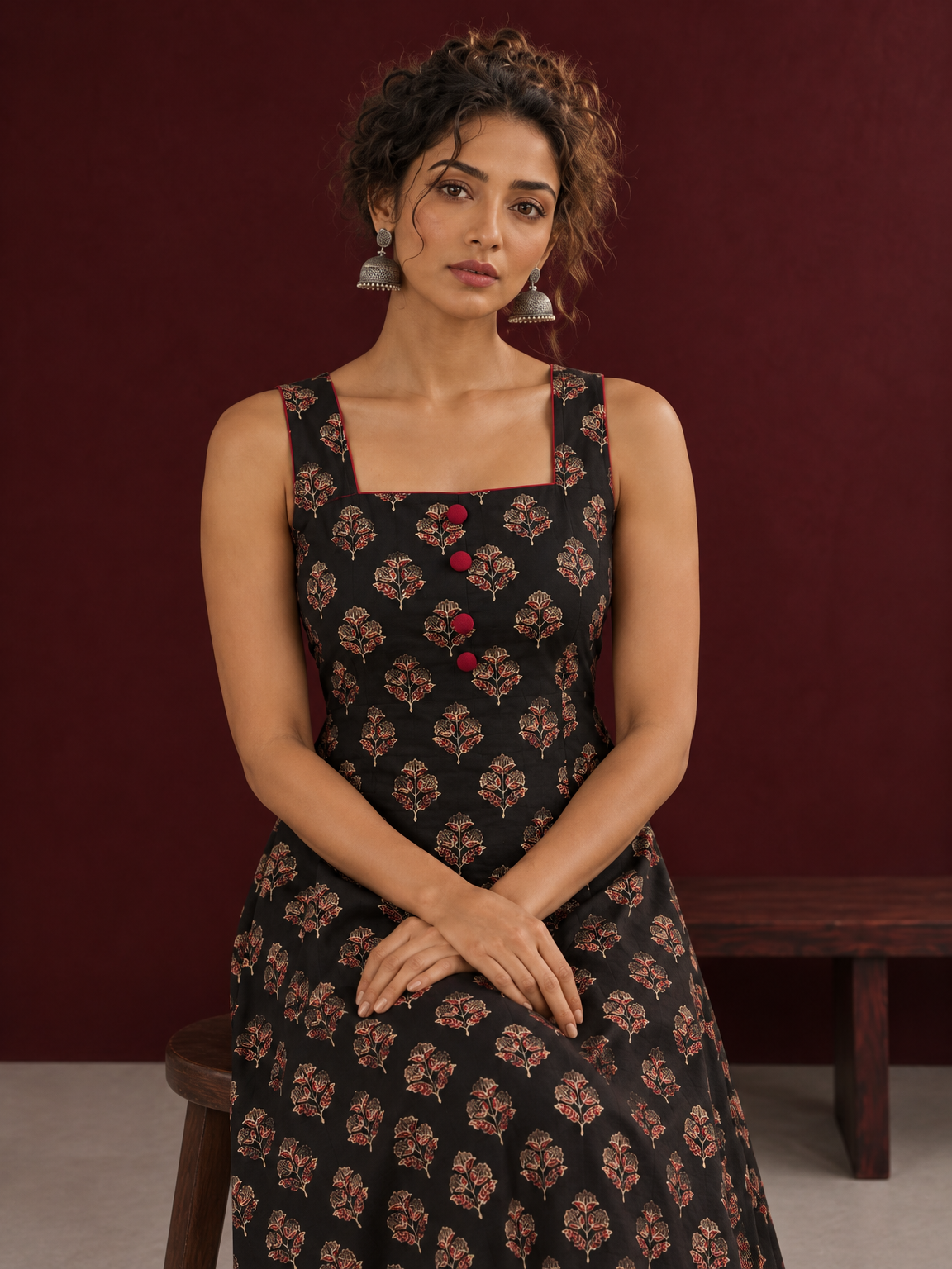 Classic Black Ajrakh Cotton Sleeveless Dress with Floral Print and Maroon Piping Square Neckline — seated detail — view 4