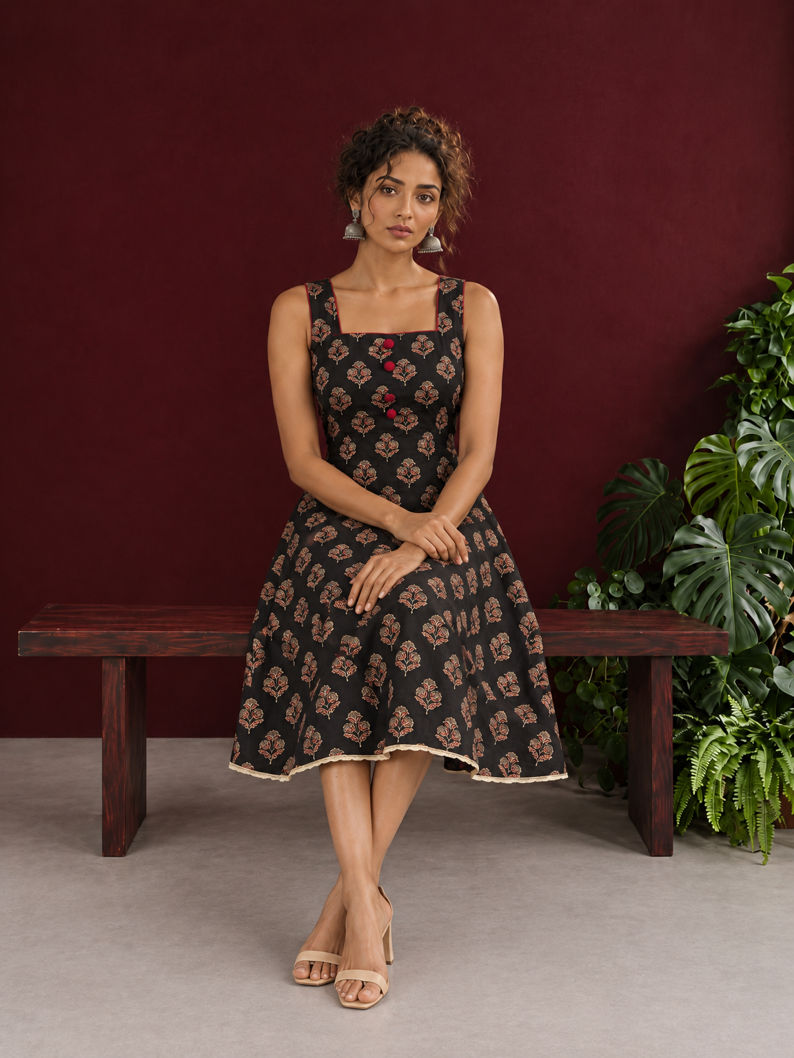 Classic Black Ajrakh Cotton Sleeveless Dress with Floral Print and Maroon Piping Square Neckline — seated — view 2