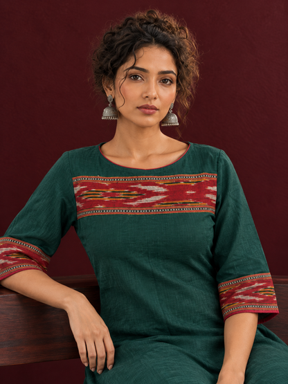 Elegant Bottle Green Cotton Dress with Contrast Maroon Ikat Yoke and Sleeve Border — seated detail