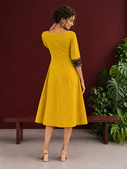 Vibrant Mustard Cotton A-line Dress with Contrast Ikat Front Panel & Coordinated Sleeve Cuffs — back view
