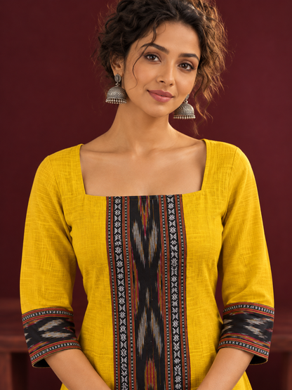 Vibrant Mustard Cotton A-line Dress with Contrast Ikat Front Panel & Coordinated Sleeve Cuffs — fabric detail