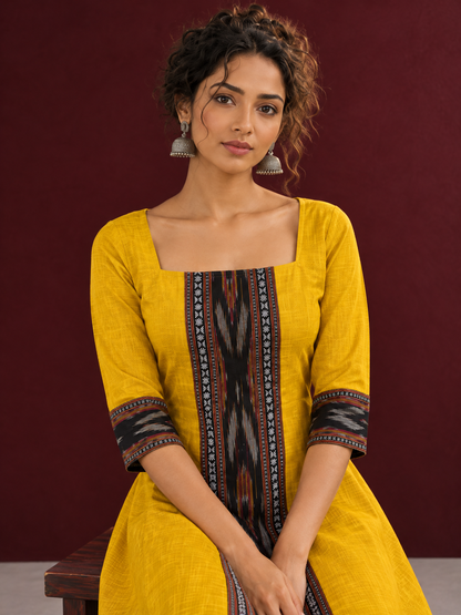 Vibrant Mustard Cotton A-line Dress with Contrast Ikat Front Panel & Coordinated Sleeve Cuffs — seated detail
