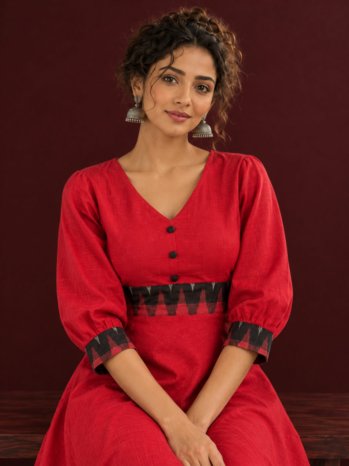 Vibrant Red Cotton Fit & Flare Dress with Contrast Black Ikat Waistband & Matching Cuffs — seated detail — view 5