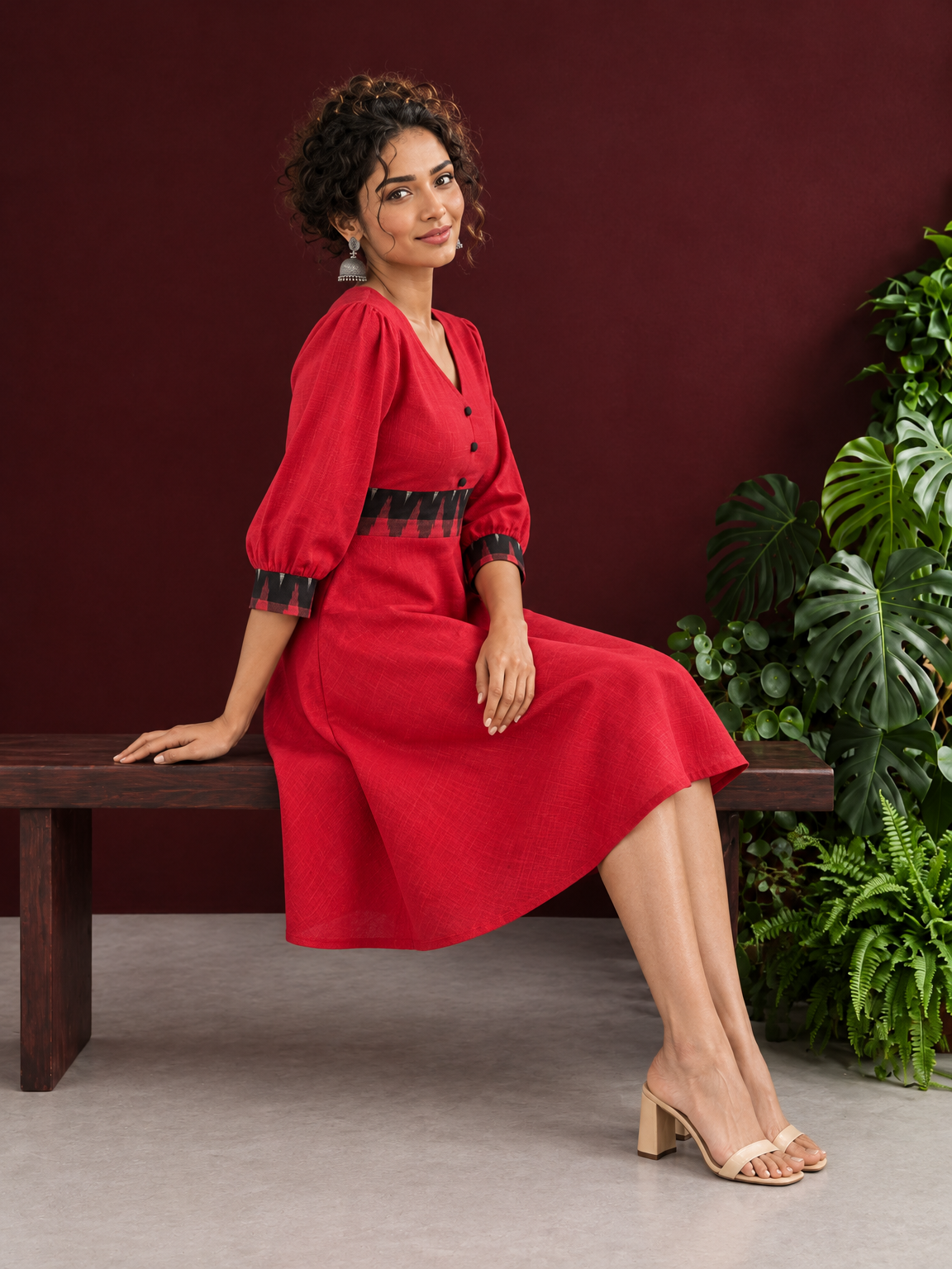 Vibrant Red Cotton Fit & Flare Dress with Contrast Black Ikat Waistband & Matching Cuffs — seated