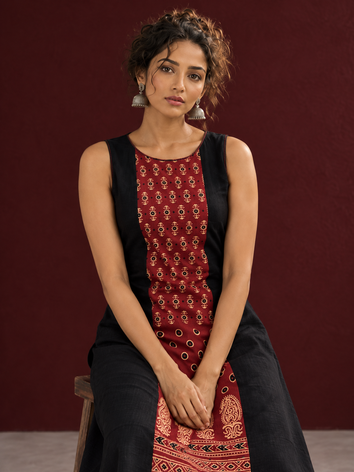 Timeless Black Cotton A-Line Dress with Maroon Ajrakh Print Center Panel & Contrast Piping — seated detail — view 5