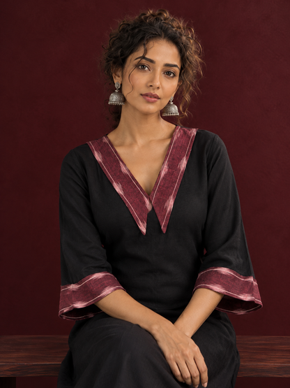 Classic Black Cotton A-line Dress with Contrast Maroon Ikat Collar and Matching Sleeve Cuffs — seated detail