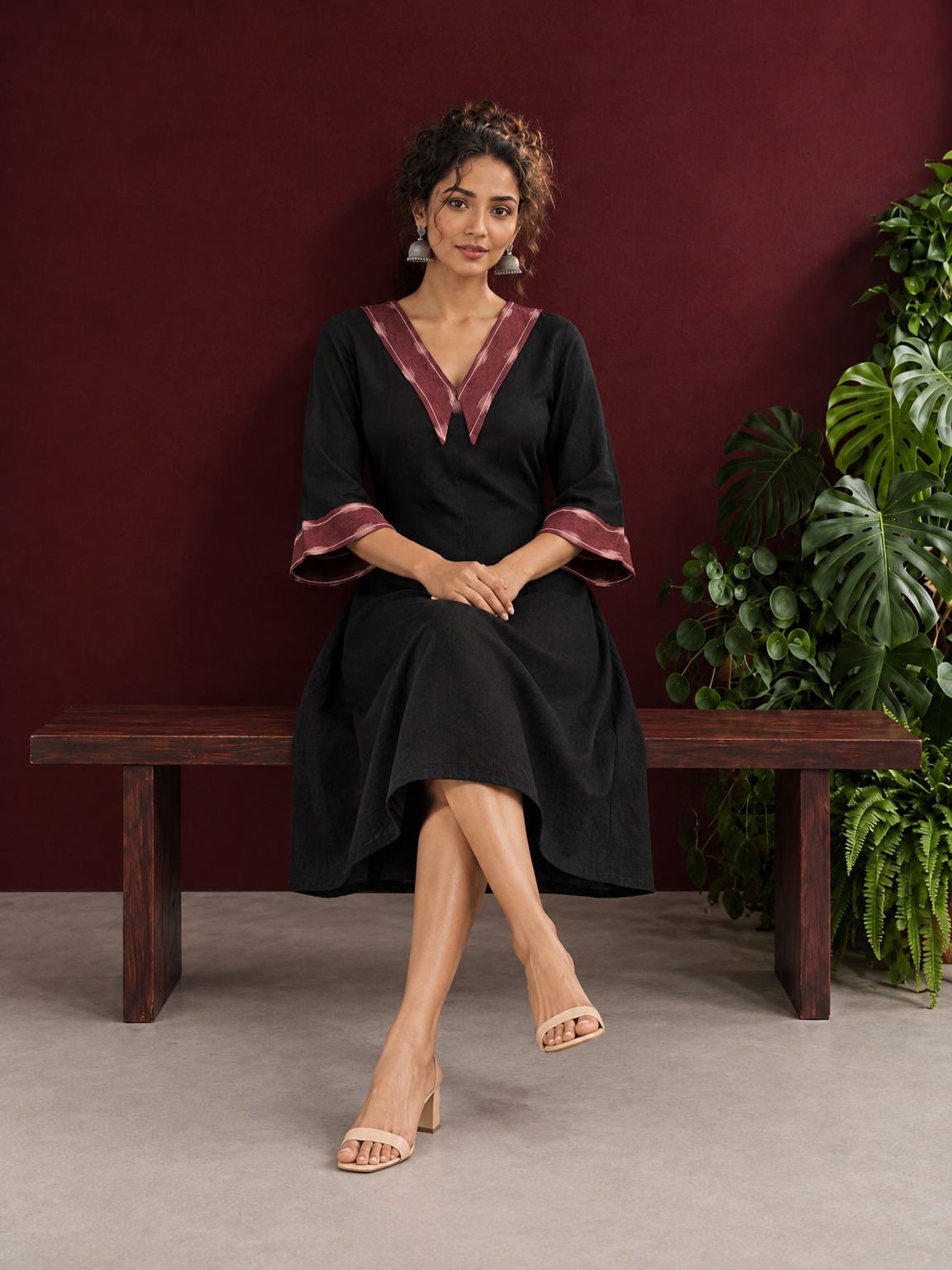Classic Black Cotton A-line Dress with Contrast Maroon Ikat Collar and Matching Sleeve Cuffs — seated — view 2