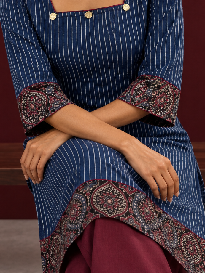 Maroon cotton pants with flowy silhouette — seated detail — view 5