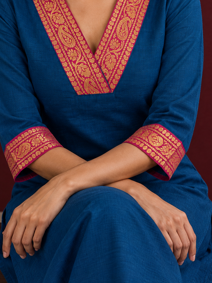 Elegant Peacock blue cotton silk pant with pink zari border — seated detail — view 5