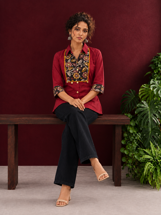 Maroon Cotton Shirt with Contrast Kalamkari Printed Yoke Panel & Sleeve Cuffs with Gold Button Detailing — seated