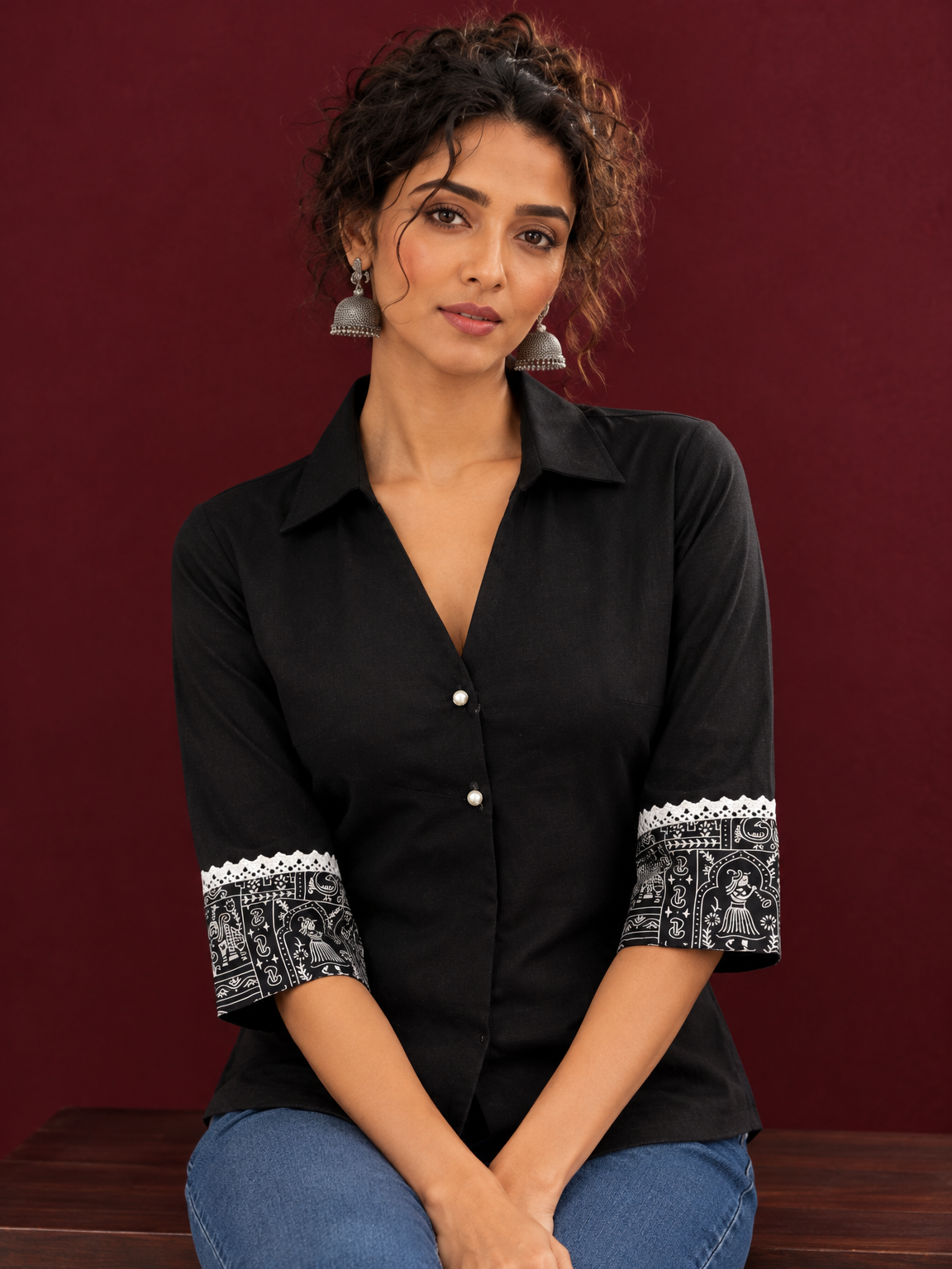Classic Black Cotton Shirt with Collared Neckline and Contrast Printed Sleeve Cuffs — seated detail — view 4