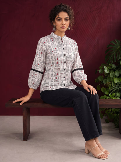 White Cotton Shirt with Warli Print, Mandarin Collar & Crochet Trimmed Full Sleeves — seated