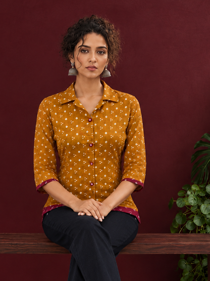 Mustard Bandhani Print Rayon Shirt with Contrast Maroon Hemline and Cuff Detailing — seated