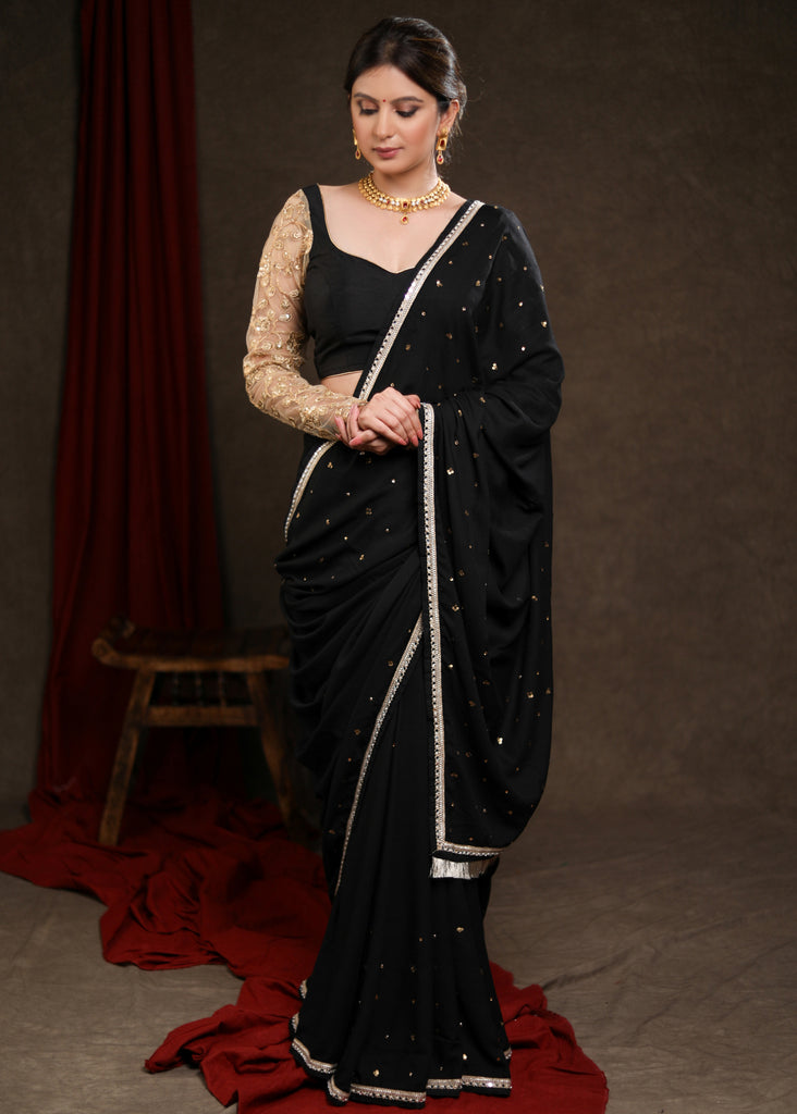 Classy Black Rayon Saree Adorned with Delicate Gold Hand Embroidery & Lace
