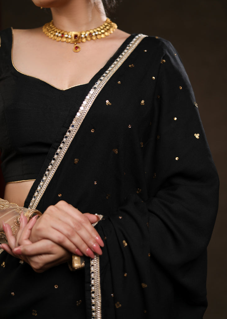 Classy Black Rayon Saree Adorned with Delicate Gold Hand Embroidery & Lace