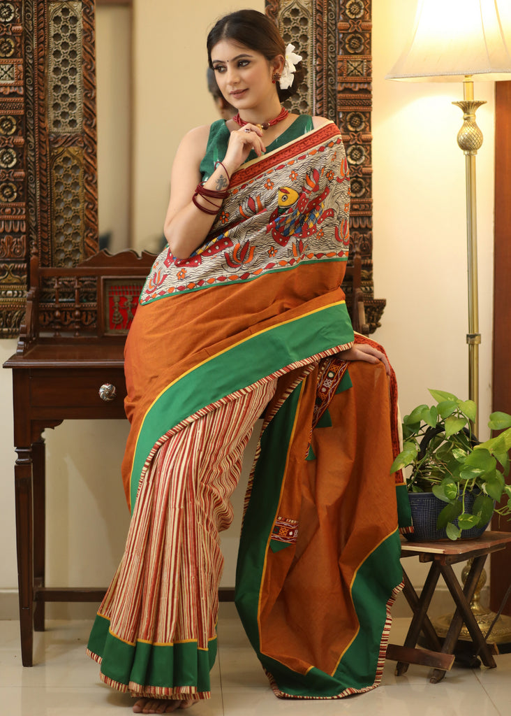 Mesmerizing rust Cotton saree with exclusive hand painted Madhubani Pallu, line pleats & mirror work border