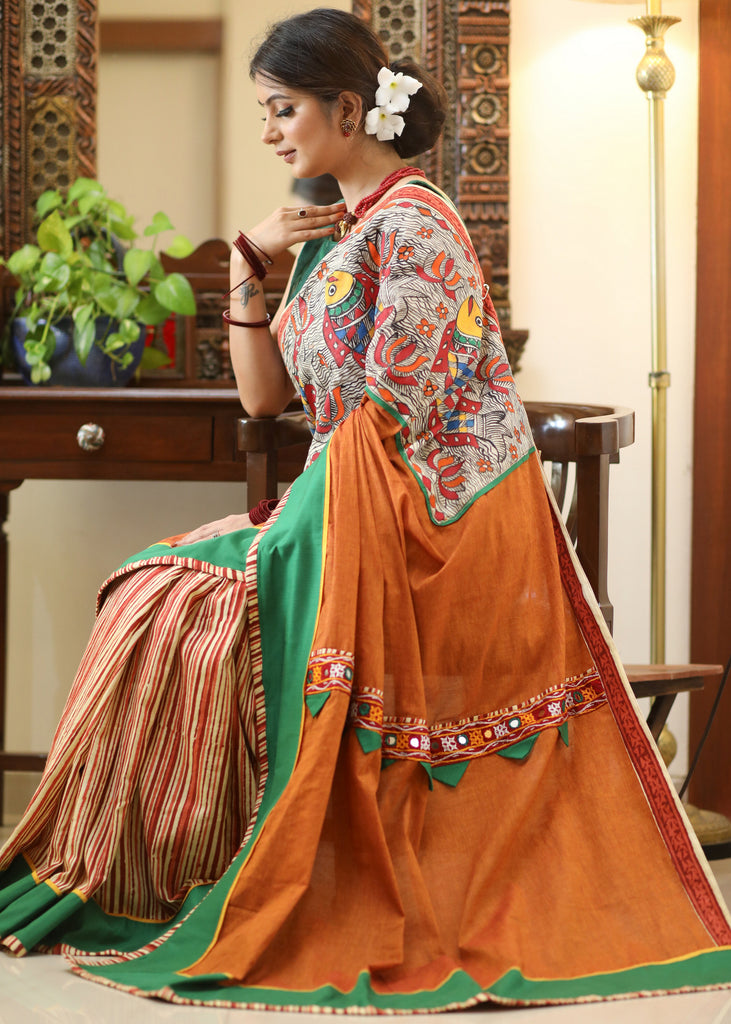 Mesmerizing rust Cotton saree with exclusive hand painted Madhubani Pallu, line pleats & mirror work border