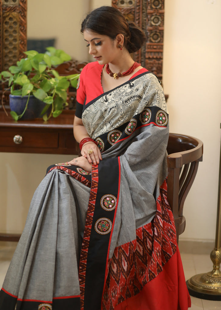 Stylish grey Cotton saree with graceful Madhubani hand painted Pallu and mirror work