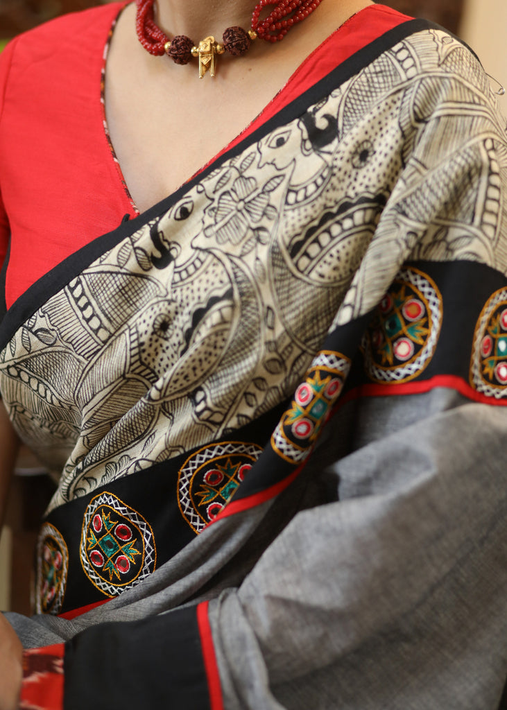 Stylish grey Cotton saree with graceful Madhubani hand painted Pallu and mirror work
