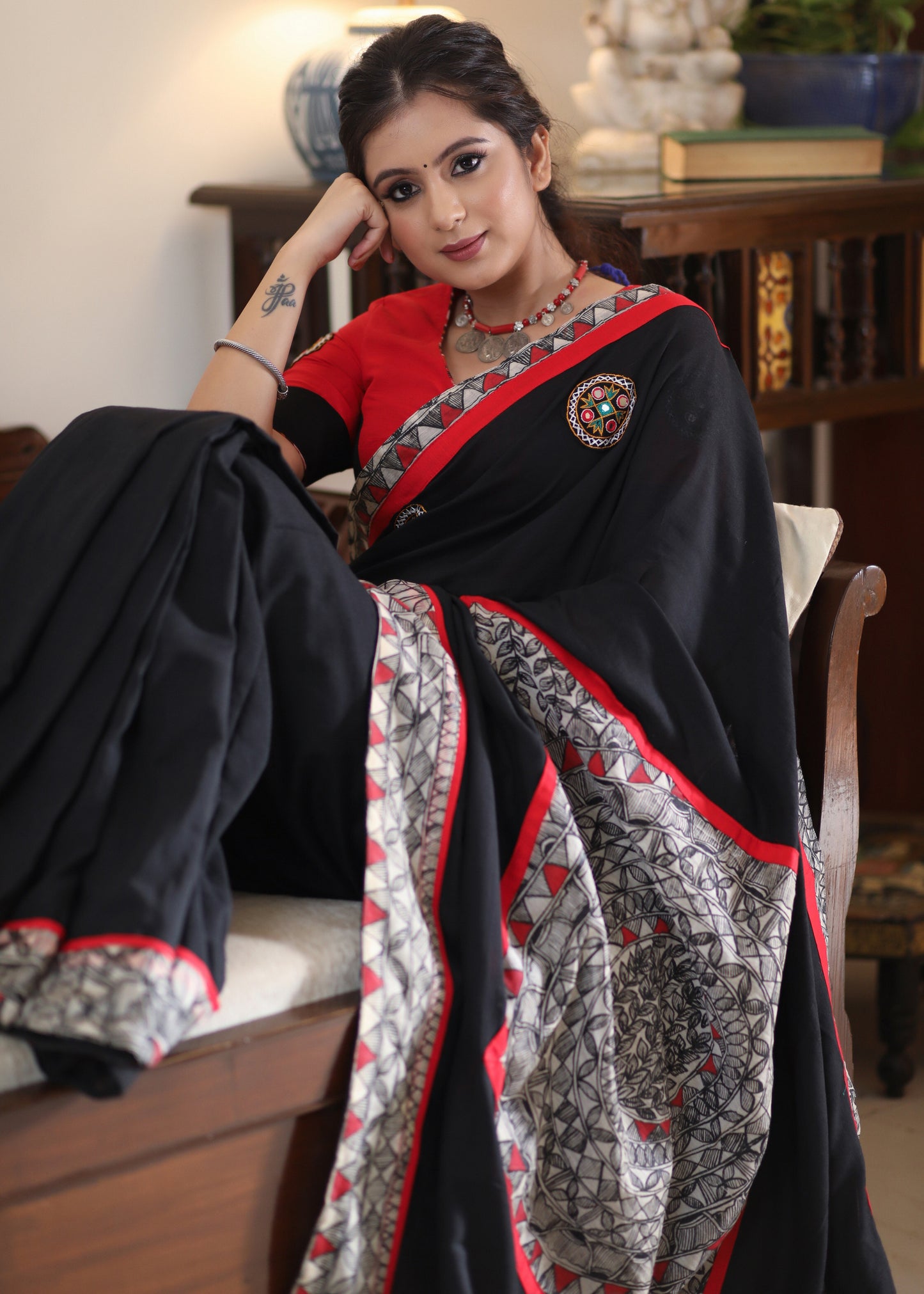 Regal black Cotton saree with Madhubani painted Pallu and border highlighted with mirror work