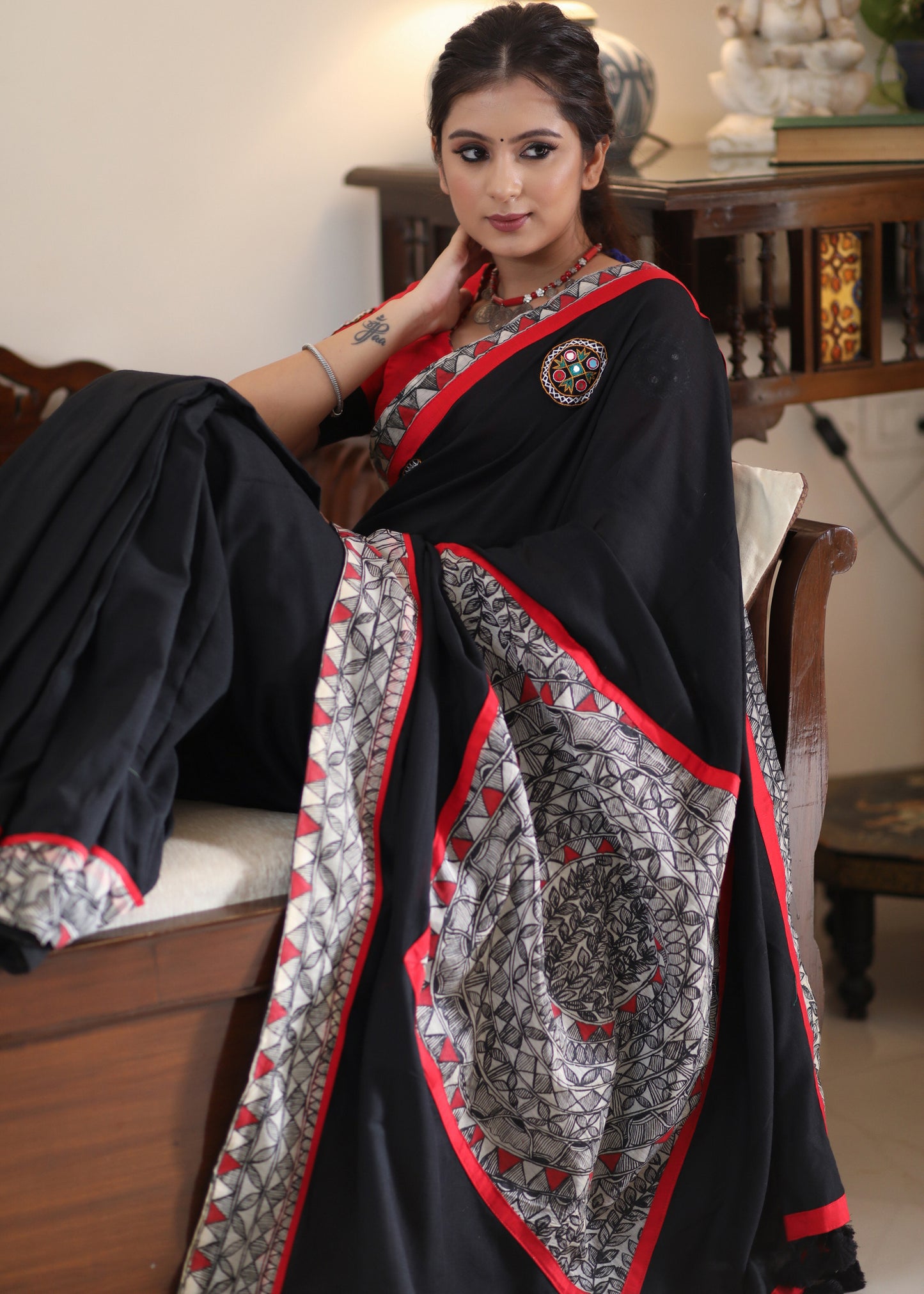 Regal black Cotton saree with Madhubani painted Pallu and border highlighted with mirror work