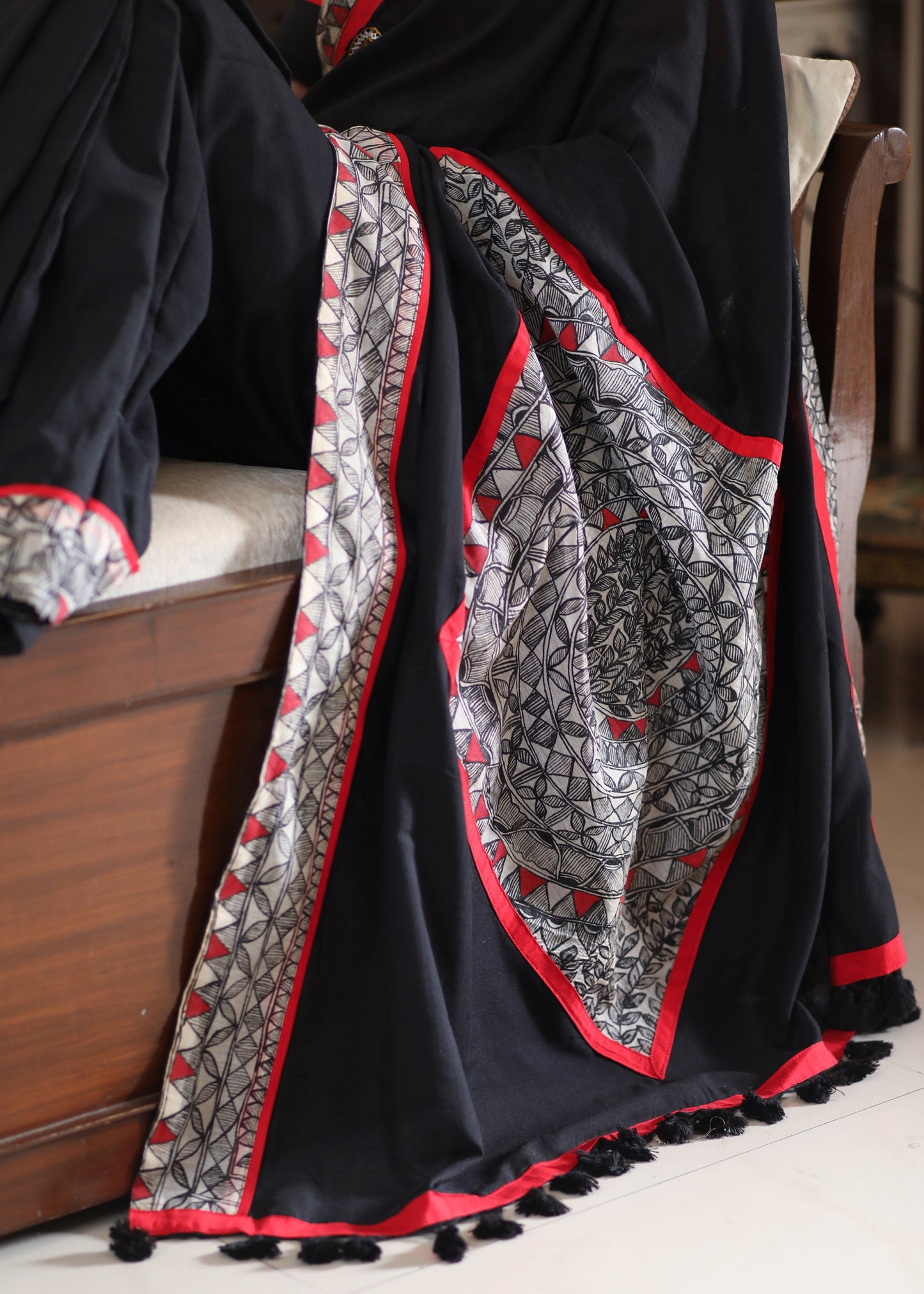 Regal black Cotton saree with Madhubani painted Pallu and border highlighted with mirror work