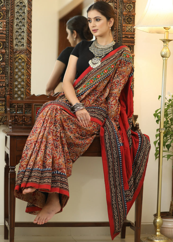 Stylish Cotton Kalamkari print saree with mirrorwork and Ajrakh border.