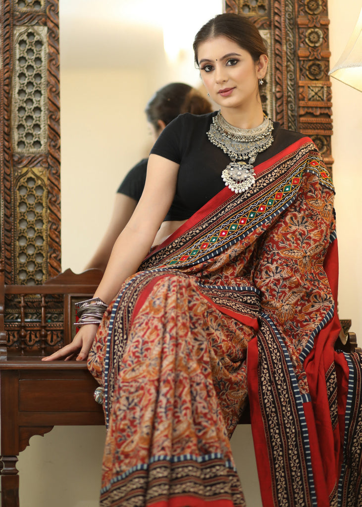 Stylish Cotton Kalamkari print saree with mirrorwork and Ajrakh border.