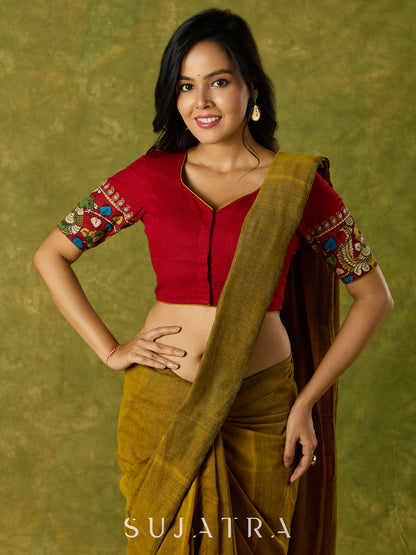 A beautifully hand embroidered maroon blouse paired with artisanal kalamkari.