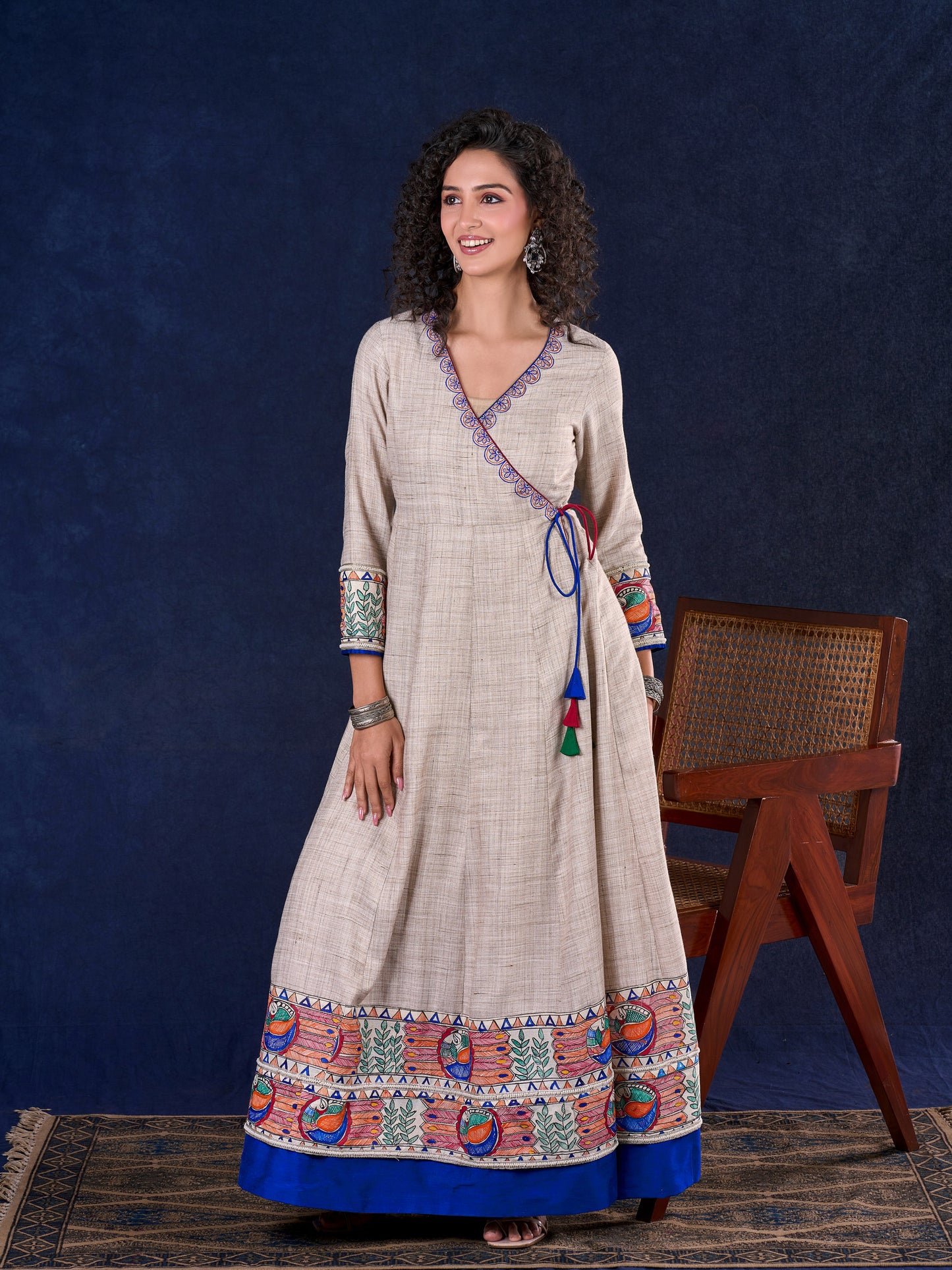 Artisanal Beige Handloom Cotton Angarkha Long Gown with Madhubani Border Embellished Neckline, Sleeve & Flare, with Vibrant Statement Tassels